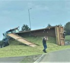 Overturned tractor trailer spills its contents all over the road