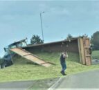 Overturned tractor trailer spills its contents all over the road